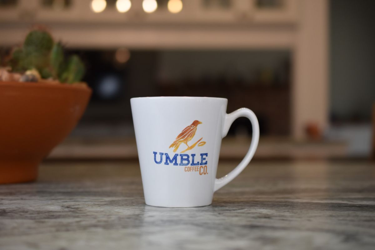 White mug with 'UMBLE COFFEE CO' logo on a marble surface